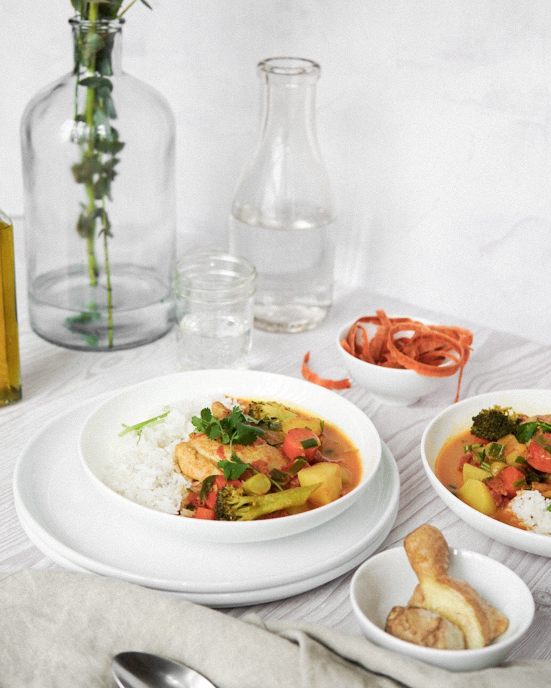 Savory tomato chicken curry plated with rice.