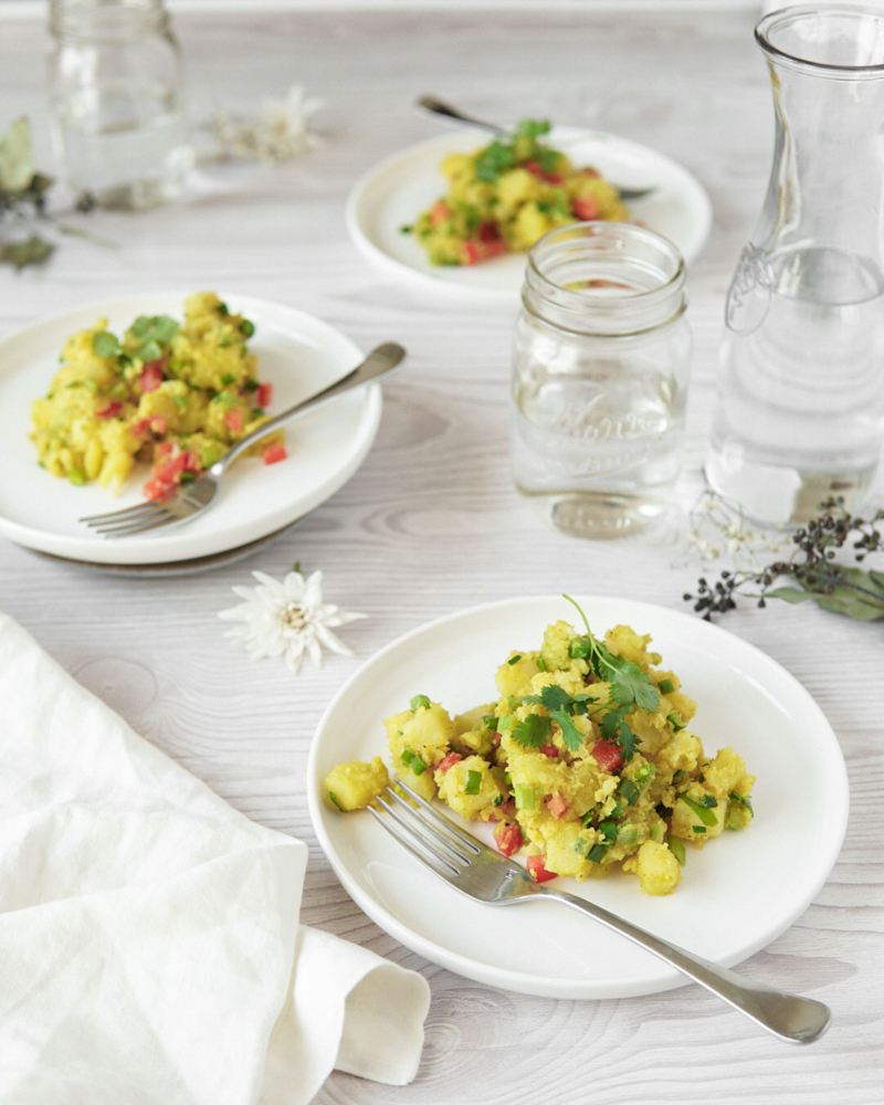 Low FODMAP Curried Potato Salad on 3 plates.