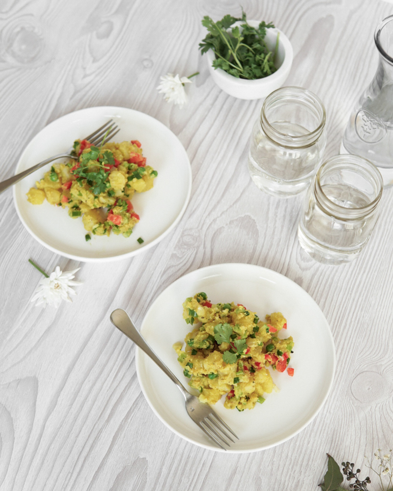 Low FODMAP Curried Potato Salad on 2 plates, ready to eat.