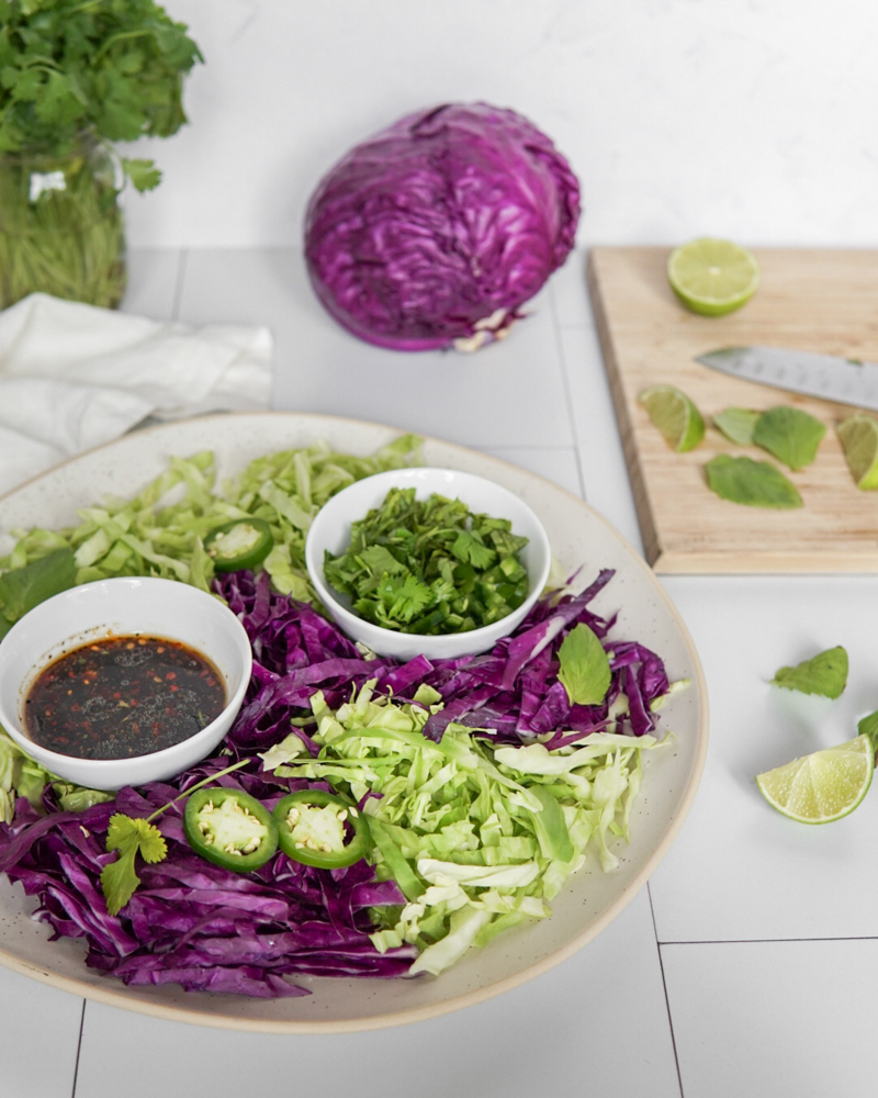 A large platter of Low FODMAP Asian-Style Coleslaw ingredients, ready to be mixed together.