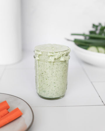 A jar of Low FODMAP, Dairy Free Cucumber Ranch, made with coconut yogurt and mayo.