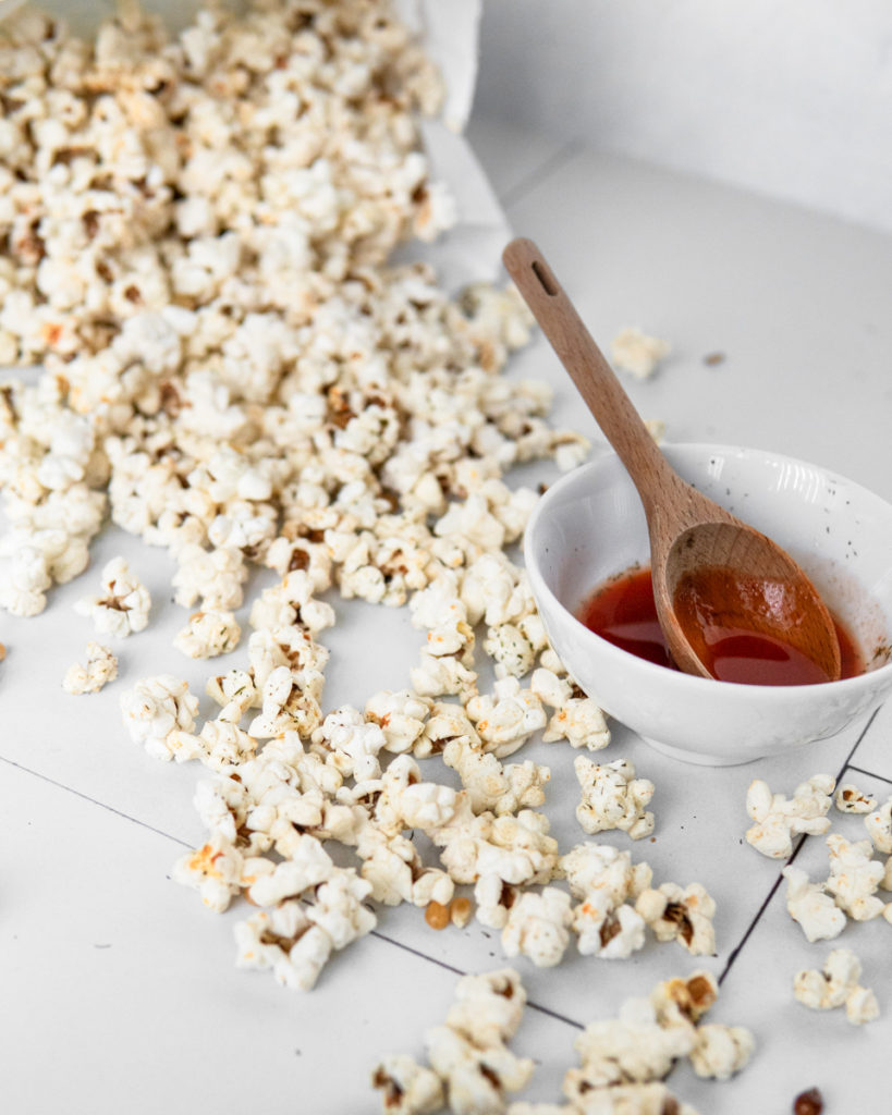 Low FODMAP Buffalo Ranch Popcorn, spilled all over the table. Oops!