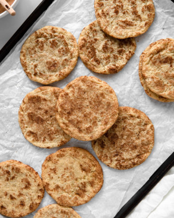A baking tray full of freshly baked Snickerdoodle cookies, Low FODMAP, grain free & dairy free-friendly.